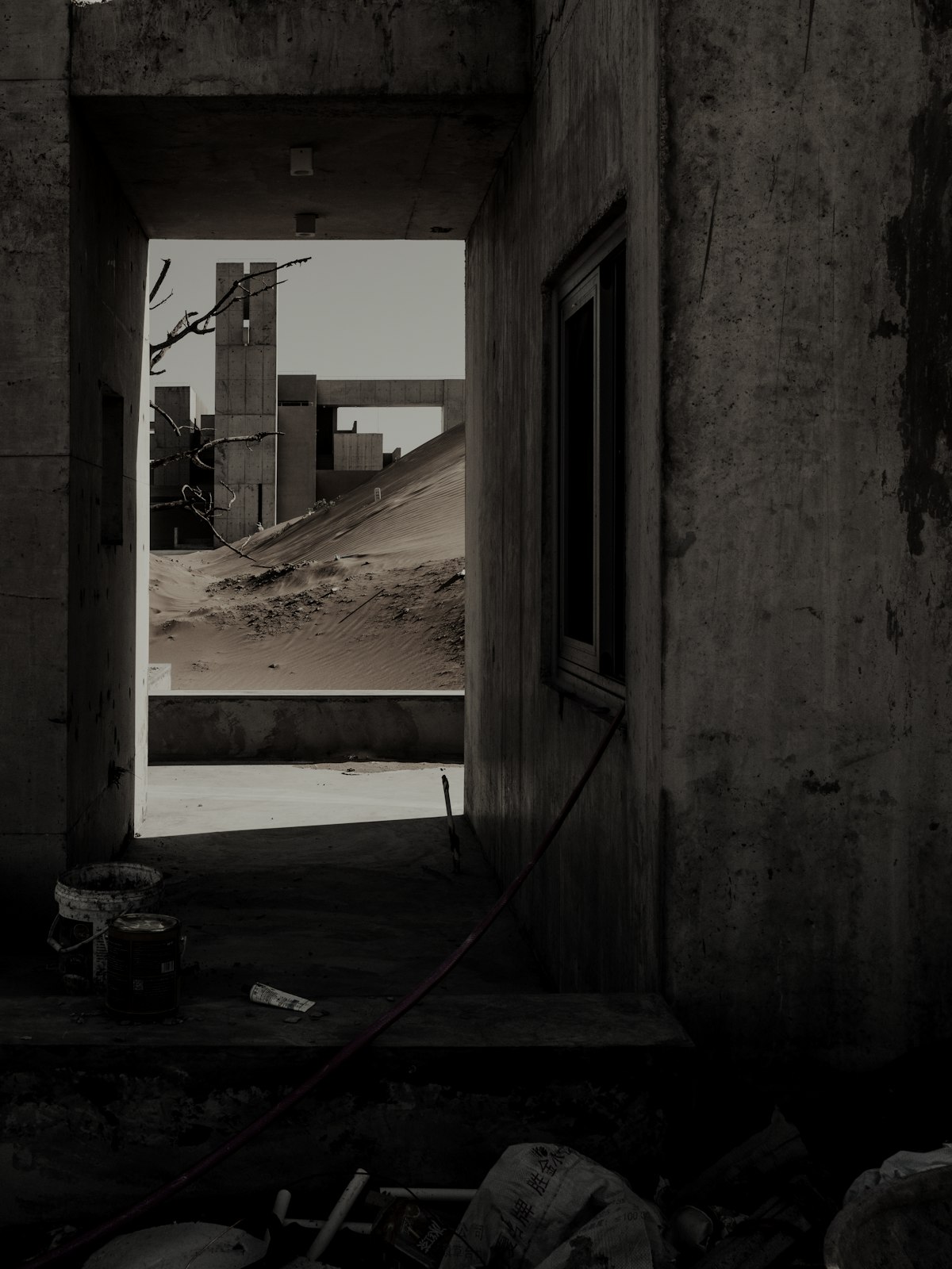 A raw concrete room opening onto the desert.