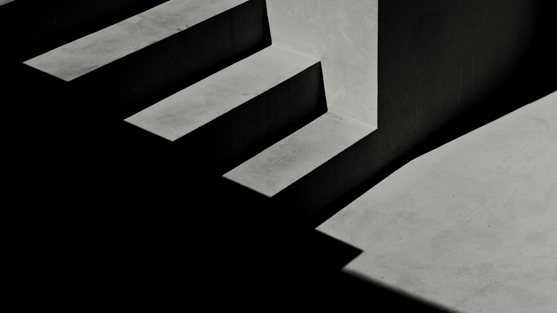 Sharp sunlight and deep shadow across a flight of concrete steps.