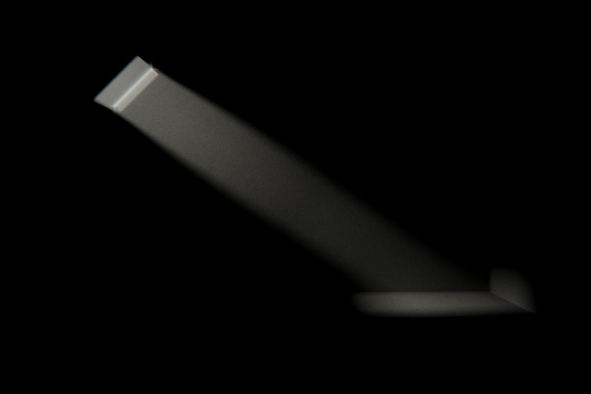 A single band of daylight falling from a narrow opening into a dark room.