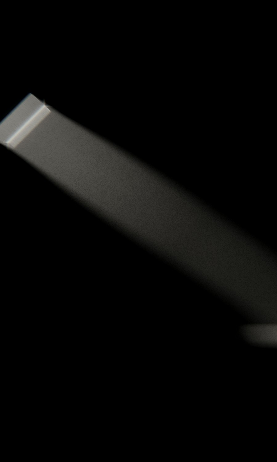 A single band of daylight falling from a narrow opening into a dark room.